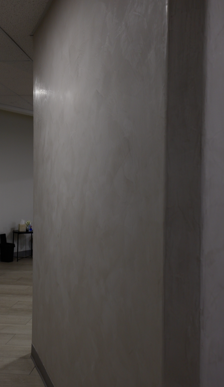 Tan sand finish plaster wall with soft sheen
